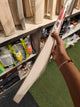 SF SS 27 English Willow Cricket Bat on display showcasing its design and craftsmanship in a sports store.