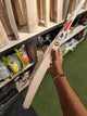SF SS 27 English Willow Cricket Bat held in hand, showcasing its design and craftsmanship.