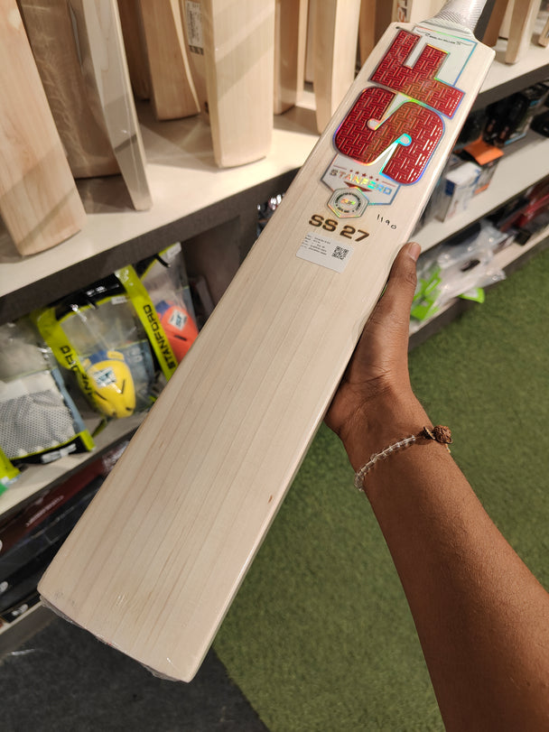 SF SS 27 English Willow Cricket Bat displayed in a shop, showcasing its quality and craftsmanship.